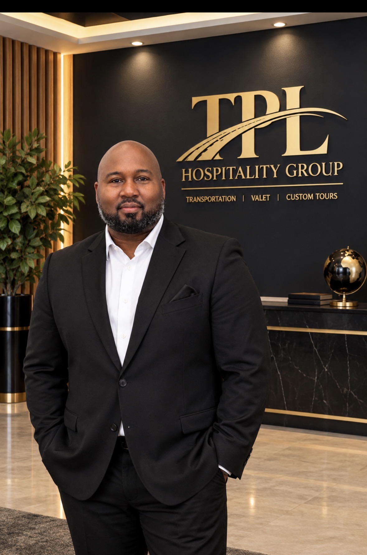 Tiant Lee, founder of TPL Hospitality Group, standing in front of the company logo